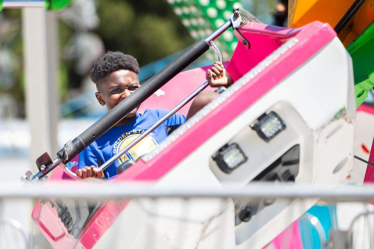 Isaac Rice, 11, clings to the safety bar of the Orbiter at the California State Fair on Tuesday. Rice said his favorite part of the ride was when it was at maximum speed.