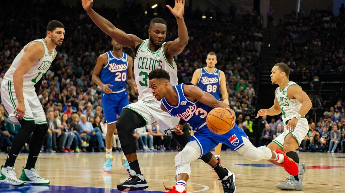 Sacramento Kings guard Yogi Ferrell (3) runs under the defense of Boston Celtics forward Semi Ojeleye (37) on Sunday, Nov. 17, 2019, at Golden 1 Center.