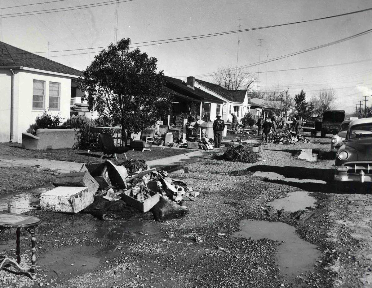 Residents of Park Avenue in Yuba City determinedly press the task of rehabilitating their homes, piling household goods and furnishing on their lawns, after the flood of Dec. 24, 1955.