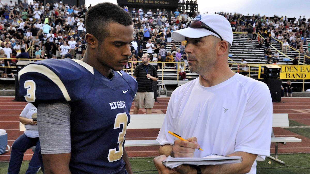 Sacramento Bee reporter Joe Davidson talks to Elk Grove High running back Arsenio Ayala after the Honor Bowl at Del Oro High School in 2014. Davidson, a stalwart of Sacramento sports journalism for more than three decades, will be enshrined in the California High School Football Hall of Fame.