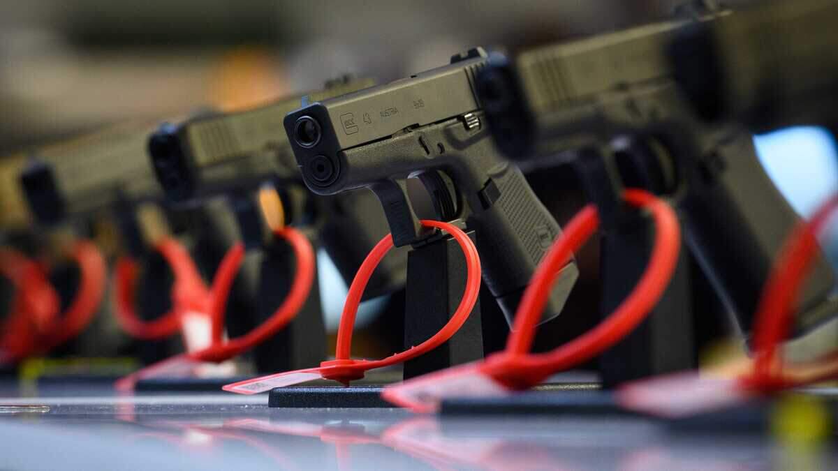 Glock handguns are displayed at the 2021 Defence and Security Equipment International exhibition in London. The Trump administration filed a federal lawsuit Wednesday challenging California laws restricting the sale of certain Glock-style pistols that can be converted into fully automatic weapons and the state's handgun roster.