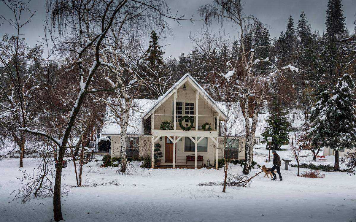 Walt Gorba of Applegate walks back home near the historic Lincoln Highway with his dog Bizou own Monday, Dec. 27, 2021, during a snow storm in the area.