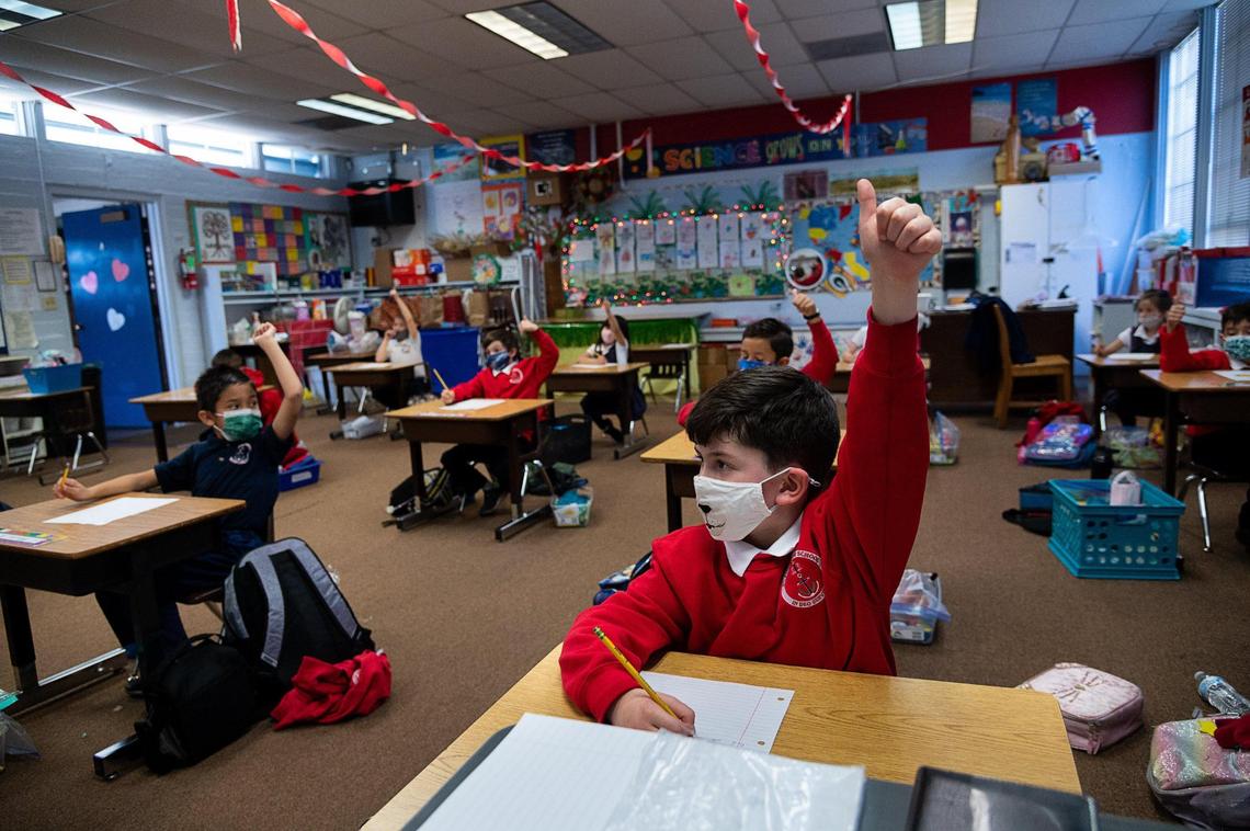 Joseph Markstein, 7, wears a face mask during his first-grade class at Saint Philomene School on Wednesday, Feb. 10, 2021, in Sacramento. Last fall his parents made the decision to take him out of his San Juan Unified elementary school and enroll him into Saint Philomene School, a Catholic School in the Arden Arcade area.