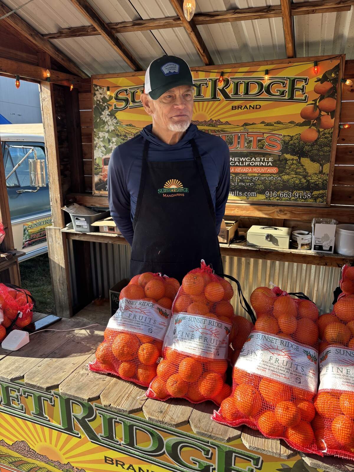 Greg Lewis, owner of Sunset Fine Fruits, an organic citrus farm in Newcastle, sells mandarins at the 32nd annual Mountain Mandarin Festival on Sunday Nov., 22, 2025, in Roseville.