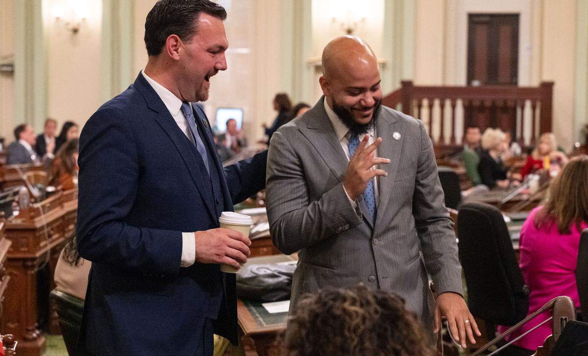 Assemblymember Isaac Bryan, D-Los Angeles, makes the sign of the cross as Nick Schultz, D-Burbank, shares news of Pope Leo XIV’s election during the Assembly session on Thursday, May 8, 2025.