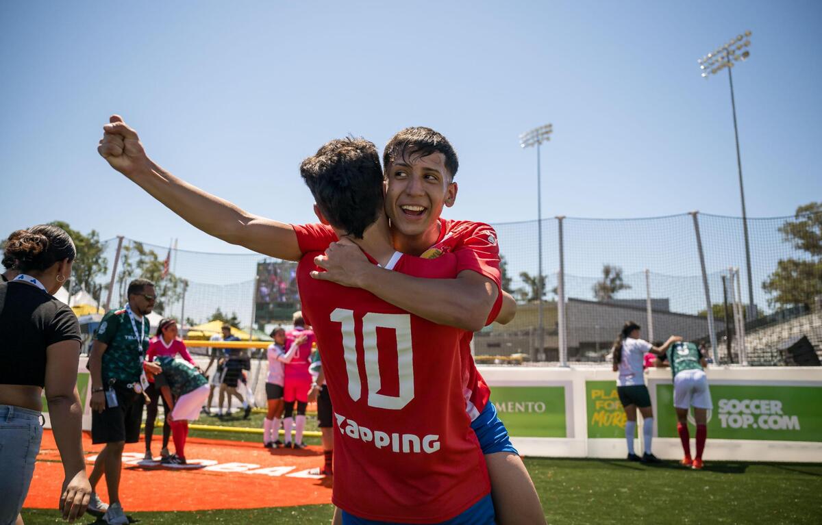 Members of the Chile men’s team celebrate their victory over Mexico for the championship at the Homeless World Cup on Saturday at Sacramento State’s Hornet Stadium.
