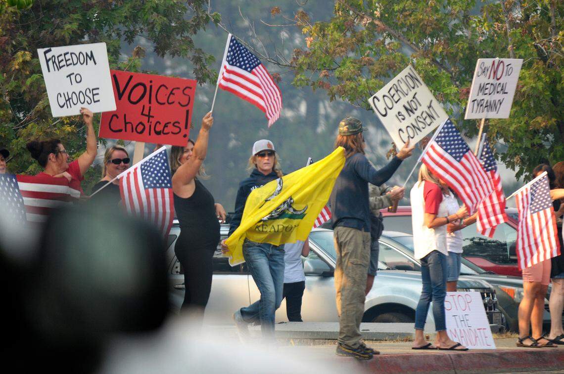 A group of about 30 people gathered along Ridge Road in front of Nevada Union High School in Grass Valley on Monday, Aug. 23, 2021, protesting a decision by school officials requiring students to test for COVID-19 or provide their vaccination status following a school outbreak.
