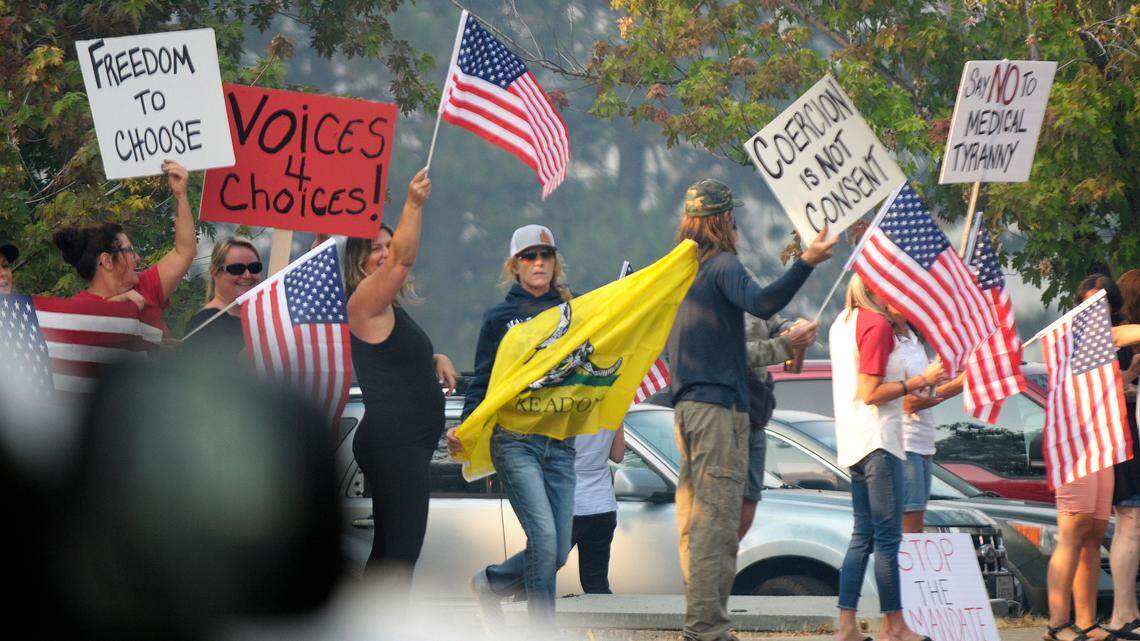 A group of about 30 people gathered along Ridge Road in front of Nevada Union High School in Grass Valley on Monday, Aug. 23, 2021, protesting a decision by school officials requiring students to test for COVID-19 or provide their vaccination status following a school outbreak.