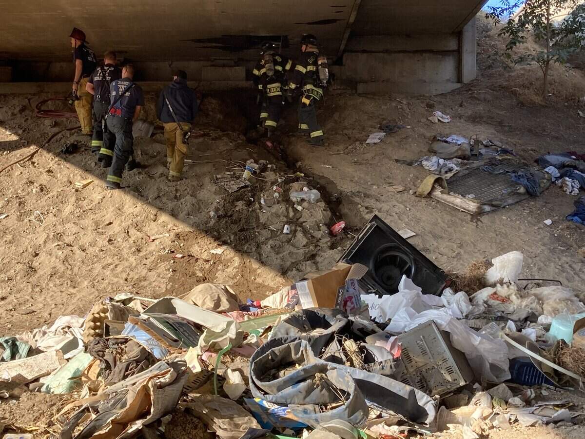 Fire personnel removed several personal belongings from the overpass.