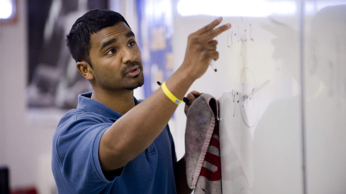 Grant High math teacher Kadhir Rajagopal helps his ninth-and tenth-grade Algebra II students with practice problems before they take a quiz in his class in 2010.