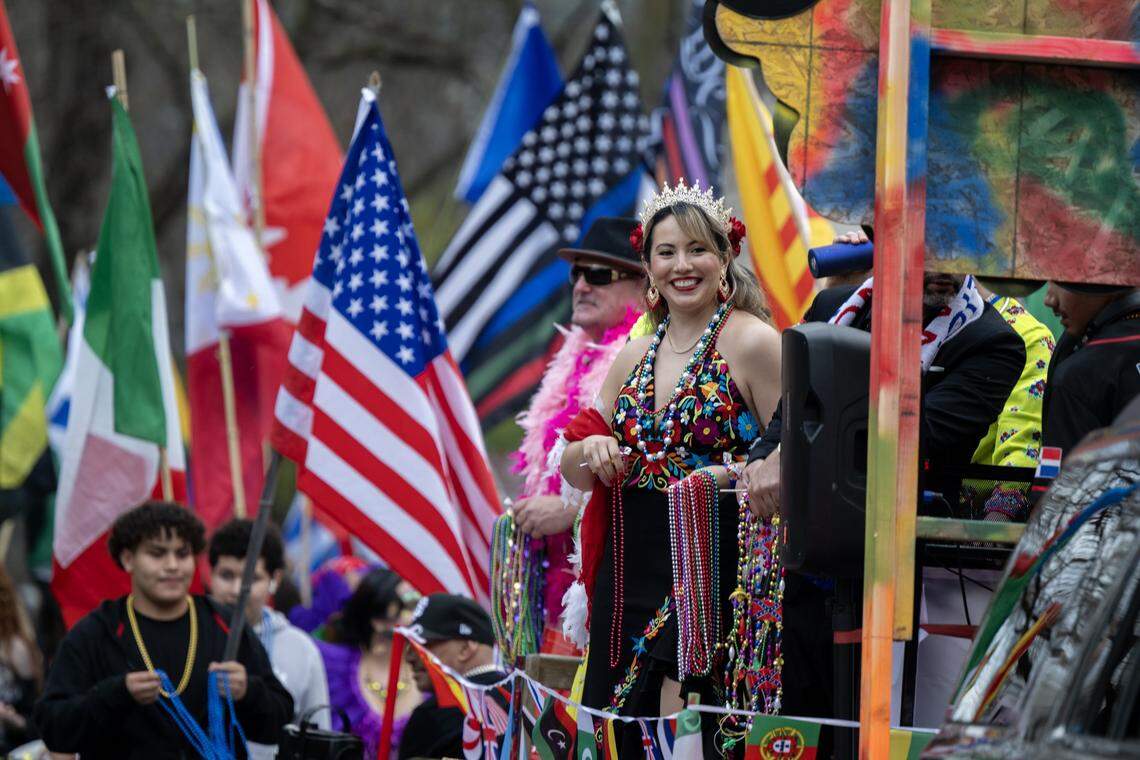 Participants from the Con-nec-tion Dance Project toss beads to the crowd on Capitol Mall during the City of Trees Parade on Saturday, Feb. 28, 2026.