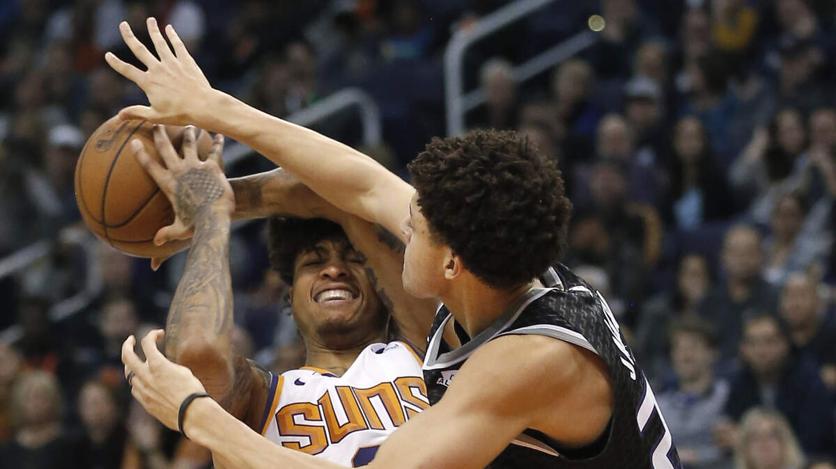 Kings forward Justin Jackson, right, defends against Phoenix Suns forward Kelly Oubre Jr. on Tuesday in Phoenix.