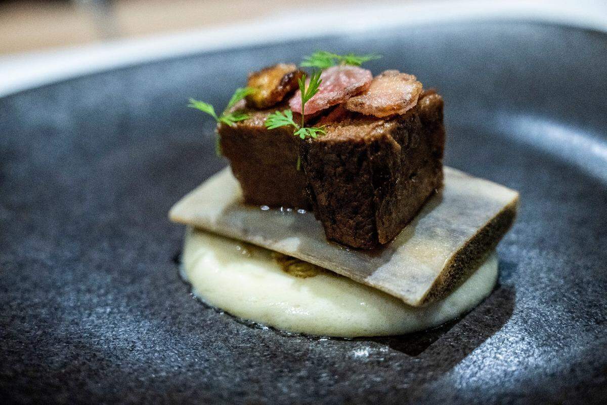 A plate of Korean-marinated, grass-fed short ribs “on the bone” with a white shoyu potato puree is part of the December tasting menu. The restaurant’s seven- or 12-course tasting menu changes every month.
