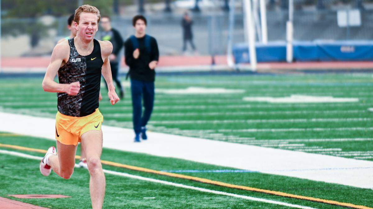 Matt Strangio pushes to complete a 1,600-meter run in under four minutes.