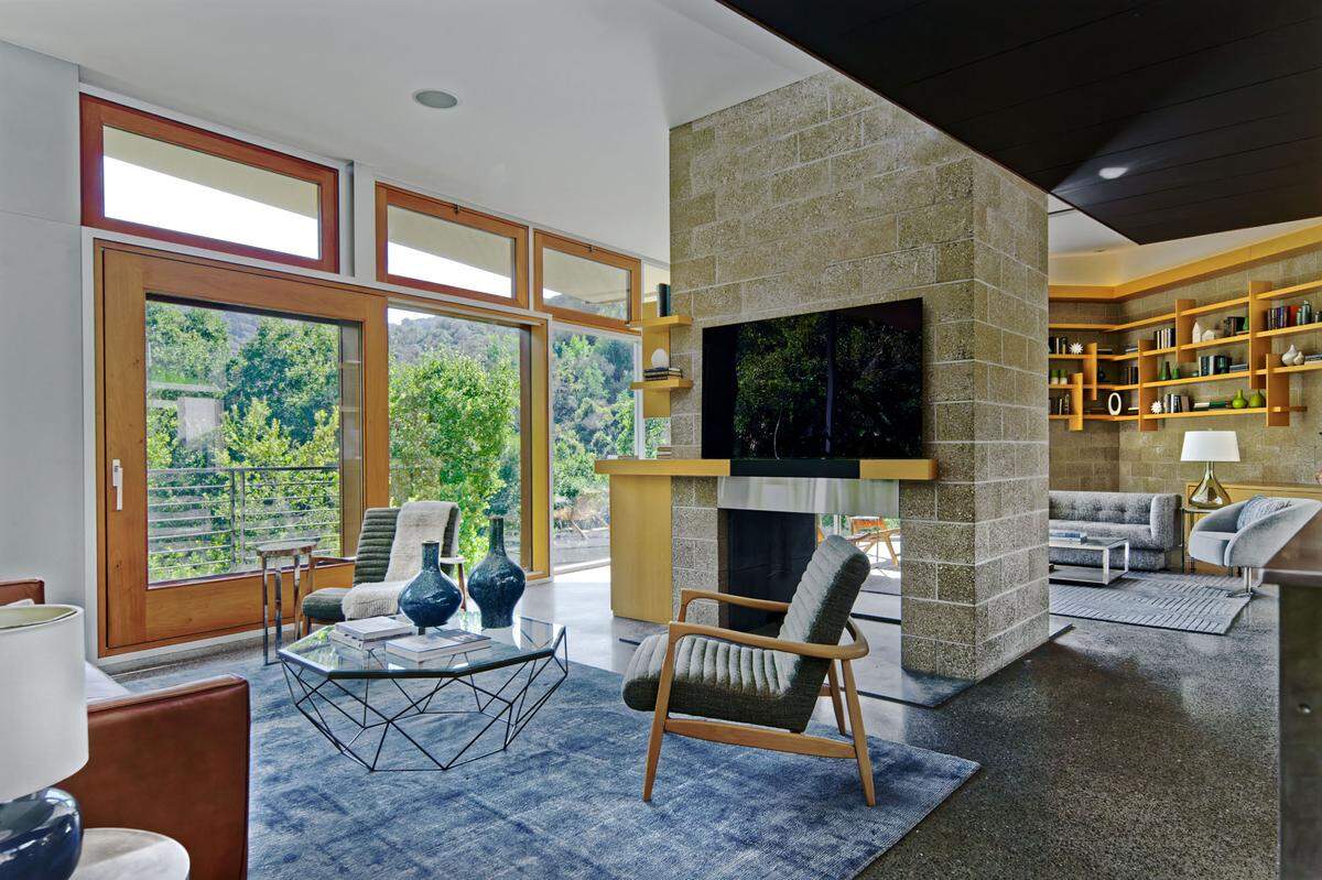 The interior is highlighted by an open-concept layout, two-way fireplace, sturdy mahogony doors and custom built-in furniture.