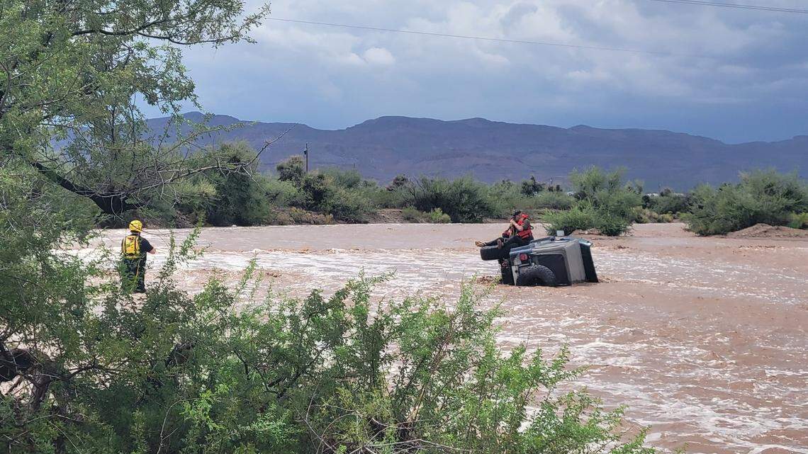 A helicopter lifted a 75-year-old man to safety after his Jeep tipped on its side in a swiftly flooding wash near Golden Valley, Arizona rescuers say.