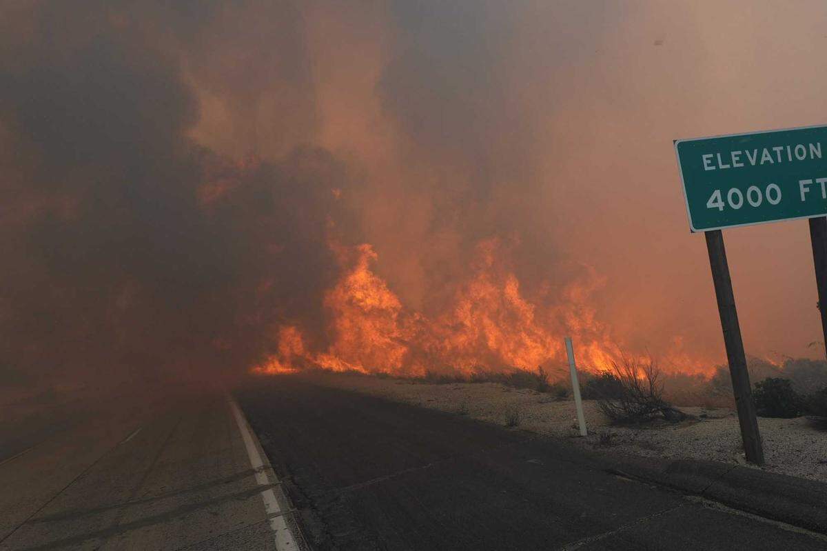 The Tusil Fire chars land next to Interstate 8 on Tuesday, May 19, 2026, near Campo. The blaze burns as about 60% of the state is in abnormal dryness or moderate drought and officials warn that disappearing Sierra Nevada snowpack could intensify fire conditions in Northern California in the months ahead.