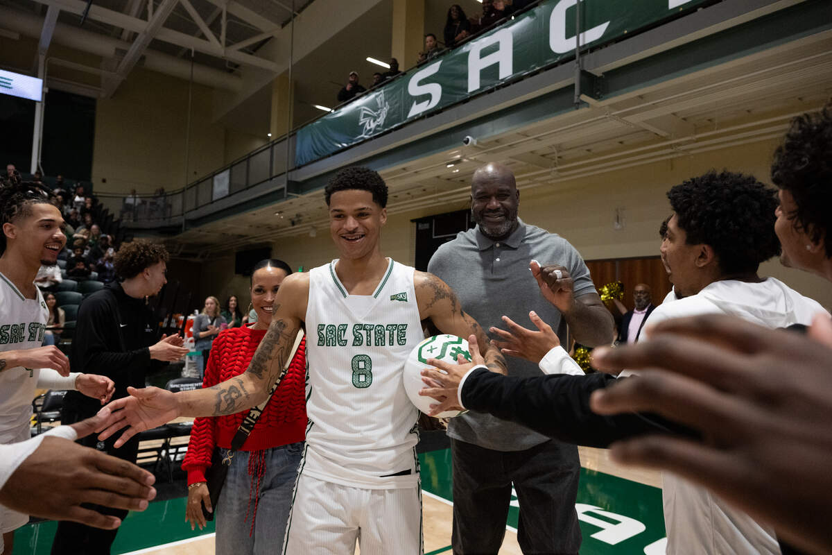 Shaqir O’Neal is joined by his parents, Shaunie Henderson and Shaquille O’Neal, as they walk him onto the court for a pregame ceremony at Sacramento State on Monday, March 2.