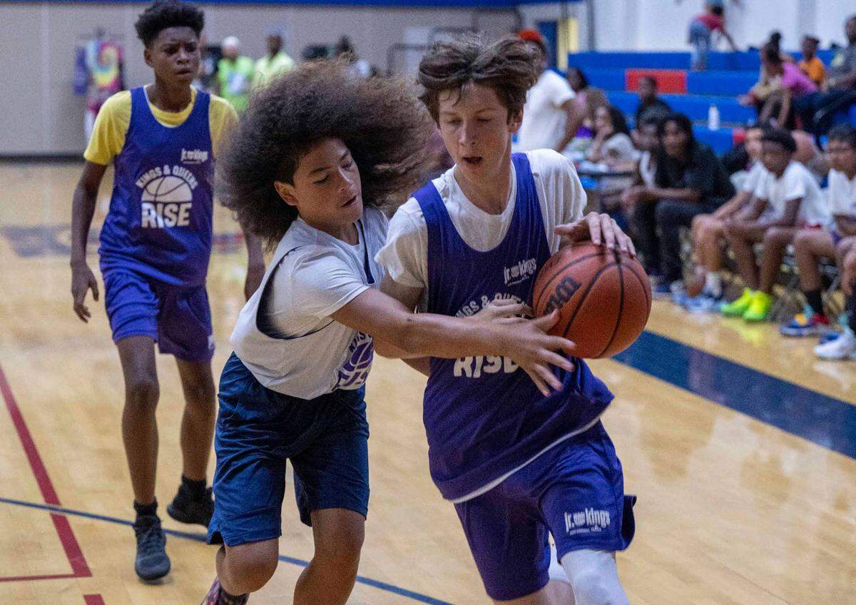 Jalani Brumfield,13, left, tries to steal the ball from Desmond Muhlhauser, 15, during a game Satruday, July 8, 2023, with youth in the Kings and Queens Rise program.