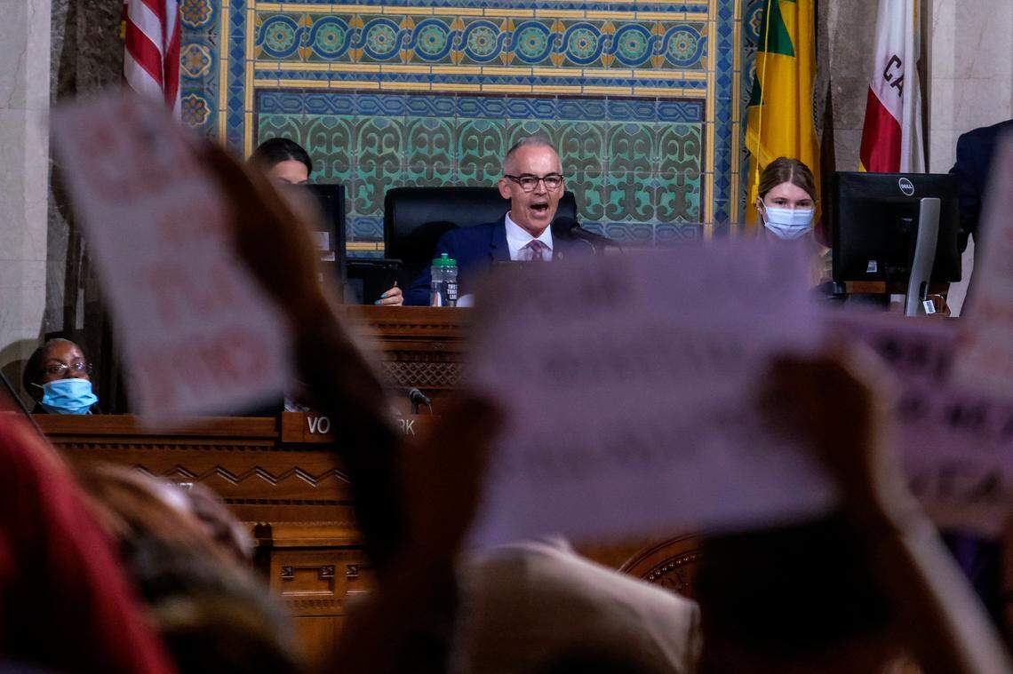 Interim Los Angeles City Council President Mitch O’Farrell, rear center, speaks before the cancellation of the Los Angeles City Council meeting Wednesday.