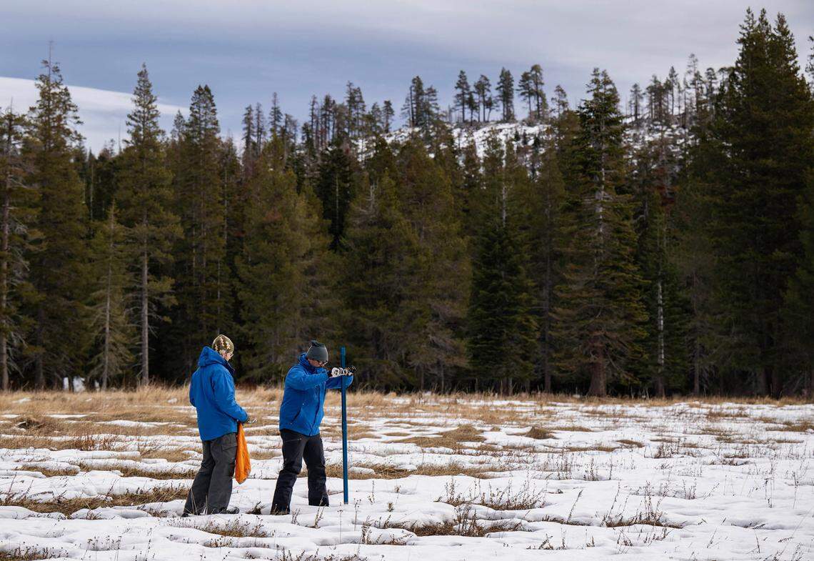 Sean de Guzman, right, snow survey manager at the Department of Water Resources, conducts the first snow survey of the season with his team at Phillips Station in El Dorado County on Tuesday.