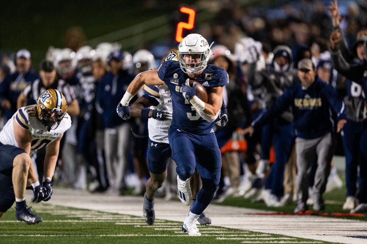 The New England Patriots signed Vallivue High grad Lan Larison as an undrafted free agent Saturday. Above, he breaks free for a first down for UC Davis in November.