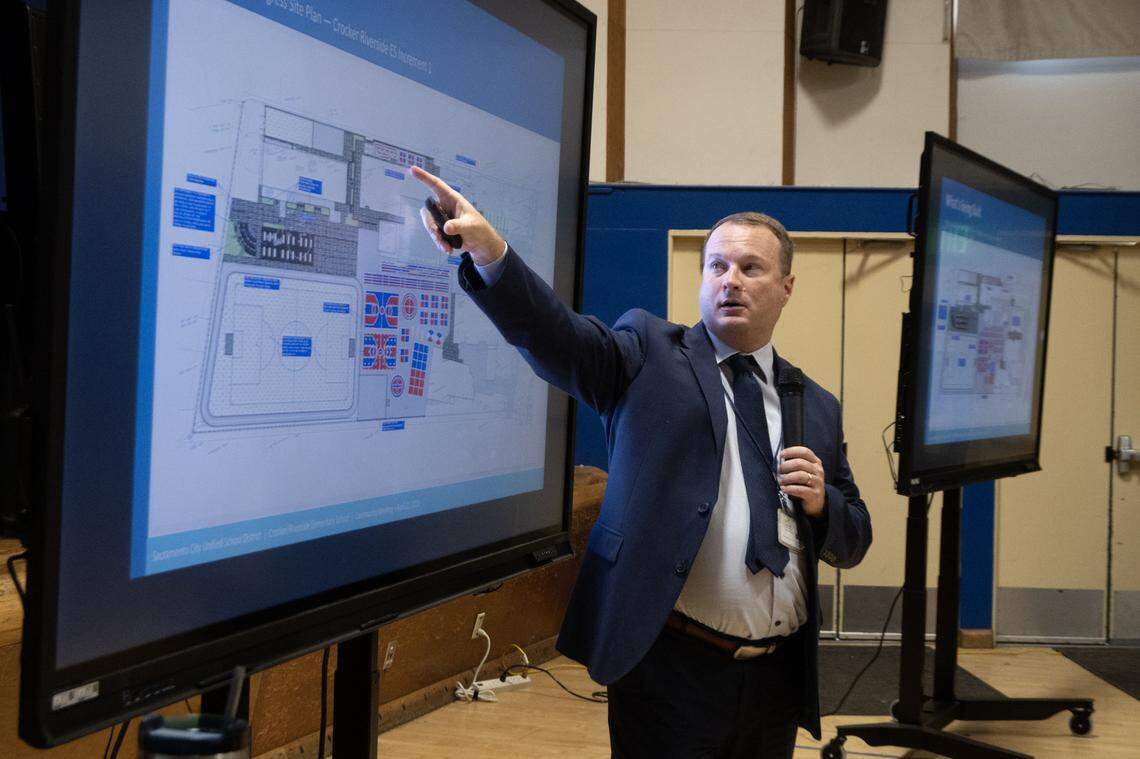 Chris Ralston, assistant superintendent of facilities for Sacramento City Unified, explains the plan to replace the existing grass field at Crocker/Riverside Elementary School with artificial turf during a meeting at the school on Tuesday.