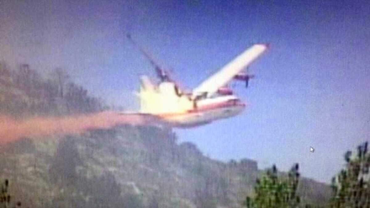 In an image from television, a C-130 air tanker plunges to the ground after breaking up over Walker, Calif. All three crew members were killed in the June 17, 2002, crash. (Photo courtesy of KOLO-TV Reno)