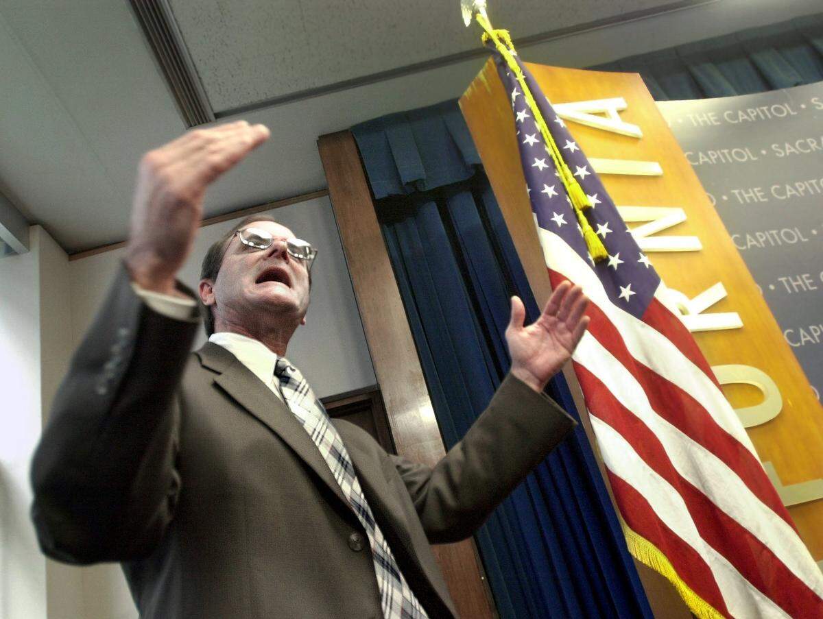 Steve Peace, then the state director of Finance, answers questions from the media after a press conference by Gov. Gray Davis in 2003.