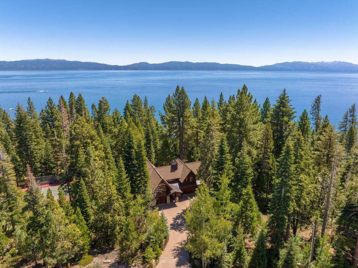 The three-home compound is private and surrounded by pine trees on a 1.6-acre lot.