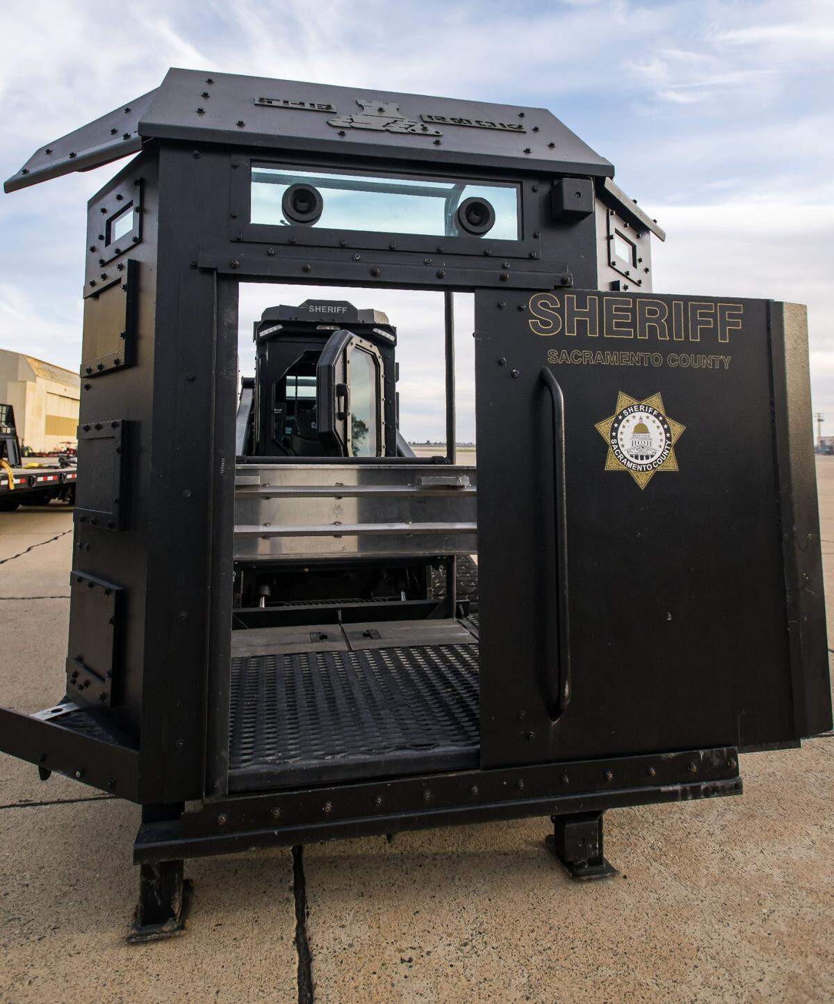 The Rook’s armored deployment platform, seen attached to the vehicle on Feb. 16, 2023, at the Sacramento County Sheriff’s facility, can hold four officers. It features six gun ports, bulletproof windows and a sliding door at front. The Rook can raise the platform 11 feet, allowing officers to reach the second and third floors of buildings.