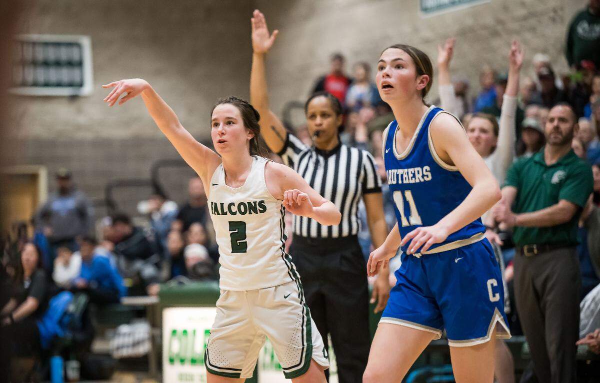 Colfax Falcons guard Jade Biittner (2), left, follow through on a three point basket as Caruthers Blue Raiders guard/forward Morgan Trigueiro (11) looks on during the fourth quarter at the CIF Northern California Division III high school girls basketball championship game Tuesday, March 7, 2023, at Colfax High School. Colfax beat Caruthers, 53-52, and advances to the state championship game Friday at Golden 1 Center.