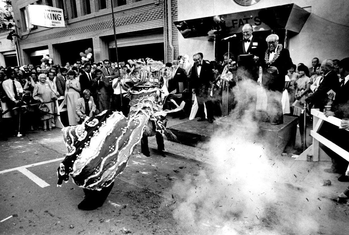 Amid exploding firecrackers and a dancing dragon, Frank Fat, at right wearing lei, celebrates his 80th birthday and the reopening of his restaurant Monday. possible gallery notable local people