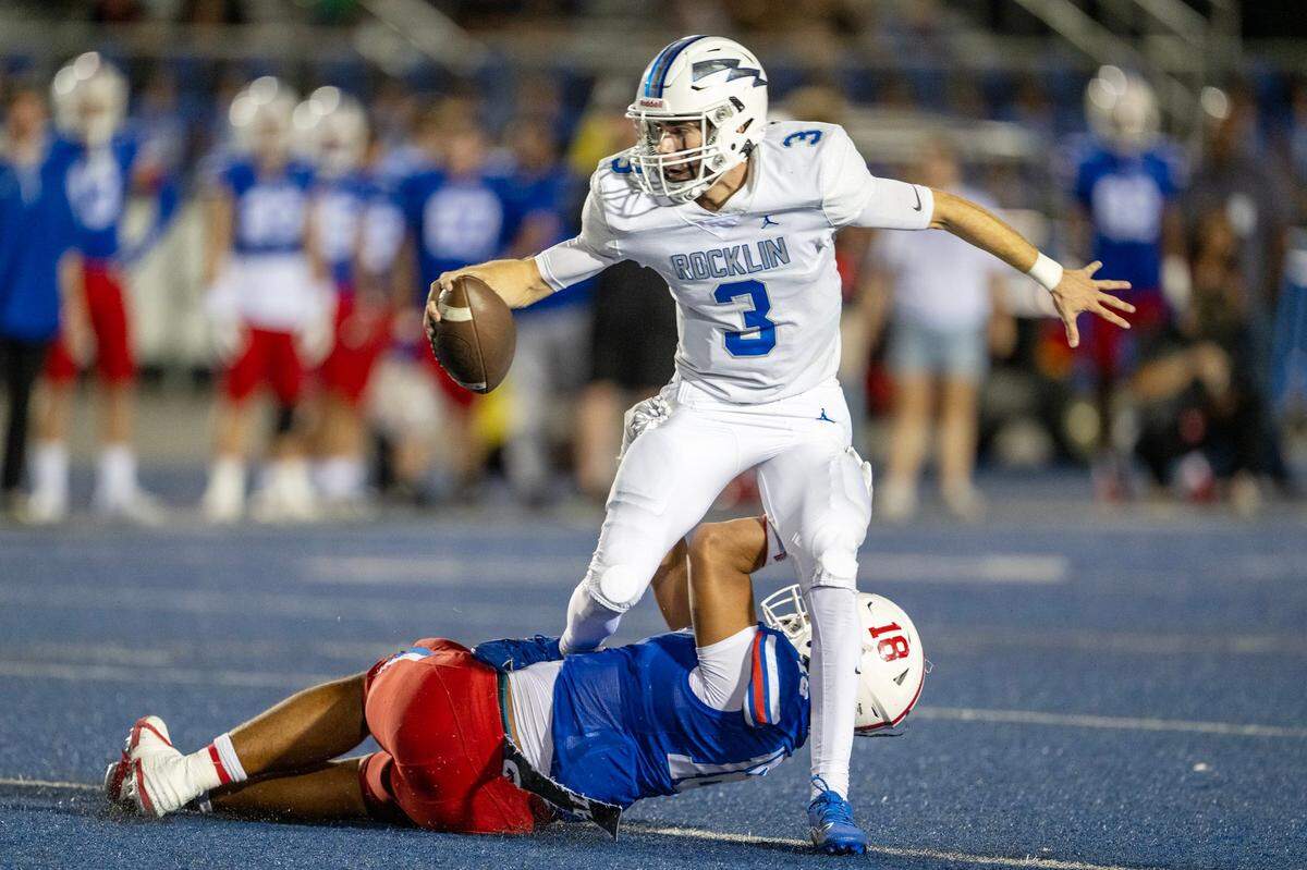 Rocklin Thunder quarterback Reeve Slone (3) is sacked by Folsom Bulldogs defensive end Taniela Tupou (18) in September. Slone was injured Friday against Whitney.