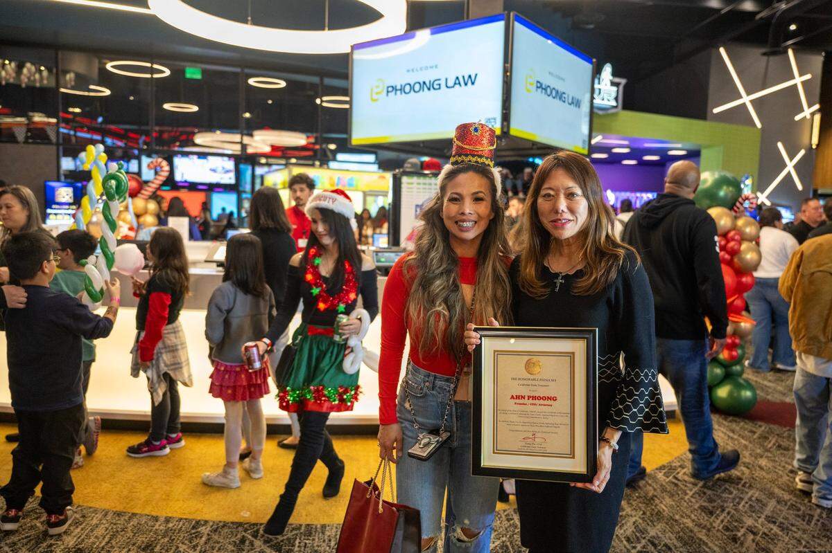 State Treasurer Fiona Ma awards a certificate of recognition to attorney Anh Phoong during the annual Phoong Law Christmas party on Friday at The Apex at Red Hawk casino.