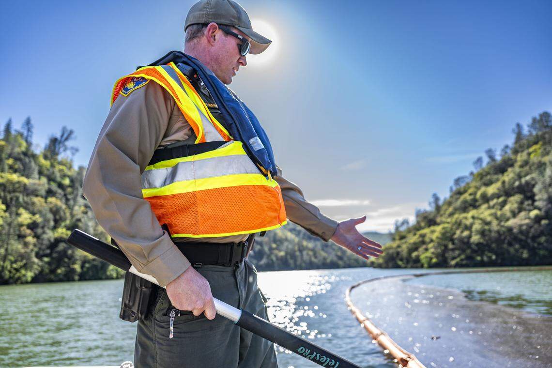 Ryan Hanson, a lieutenant with California Fish and Wildlife, points to a section of wood debris during a tour of Englebright Lake on Tuesday, March 3, 2026. The area was where contaminants were contained following the rupture of a large pipe, called a penstock pipe, at the New Colgate Powerhouse.