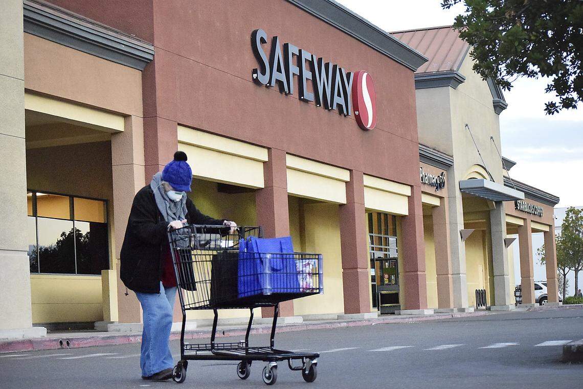 A woman walks out of Safeway on McHenry Ave. in Modesto, California on Thursday, Mar. 19, 2020. Safeway recently announced that senior citizens and other at-risk members of the community are only allowed in the store from 7 a.m. to 9 a.m. on Tuesdays and Thursdays.