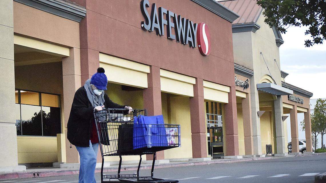 A woman walks out of Safeway on McHenry Ave. in Modesto, California in March 2020. Kroger and Albertsons, which owns Safeway, announced a merger on Oct. 14.