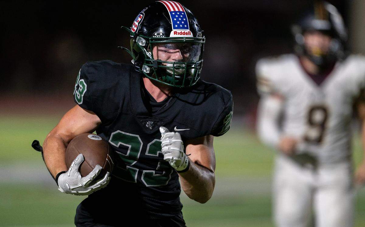 Twelve Bridges Raging Rhinos running back Braeden Ward (23) runs for a touchdown in the fourth quarter against the Whitney Wildcats on Sept. 6 at Twelve Bridges High School.