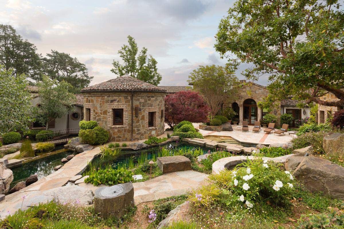 The estate has beautifully manicured landscaping.