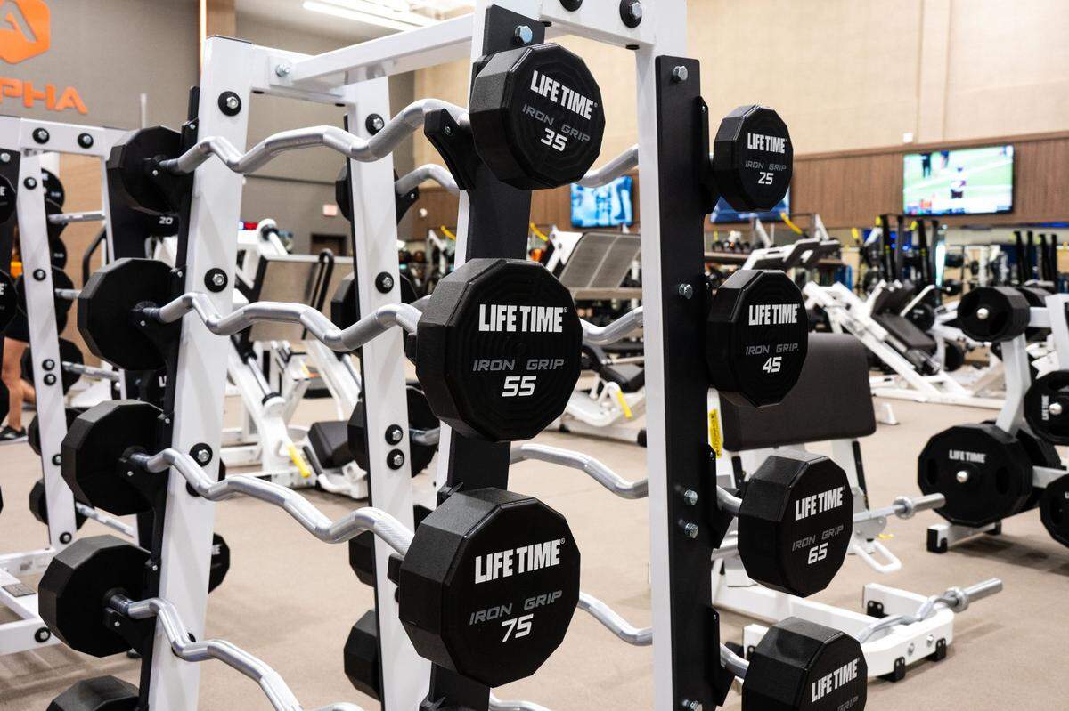 Sets of EZ Curl bars await opening day at Life Time Arden fitness club on Thursday.