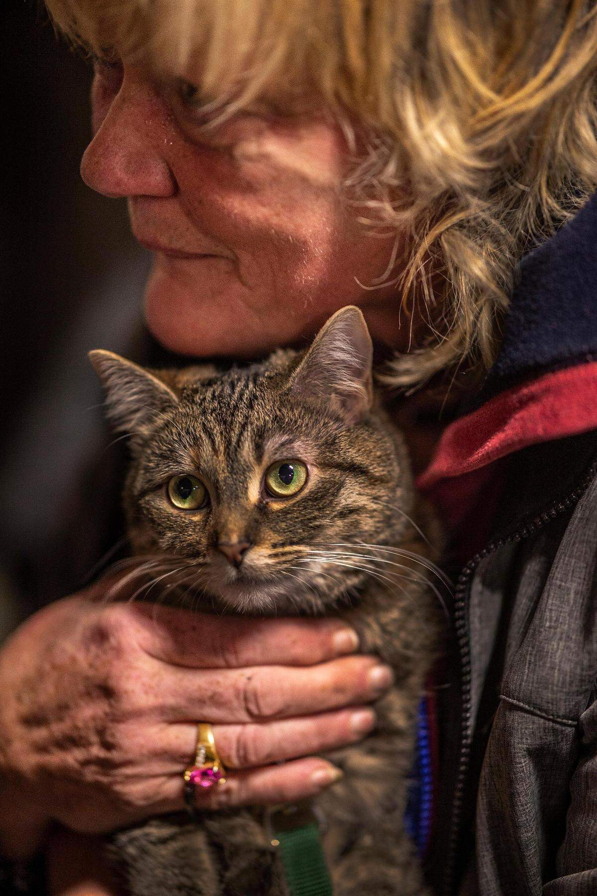 Julie Hemingway holds her cat Tammy next to her bed at Sacramento Triage Shelter on Thursday, Dec. 20, 2018. The Sacramento Triage Shelter is the only shelter in Sacramento that allows residents to live with their pets. The shelter has been open since last winter. Front Street Animal Shelter has provided its services to pets that belong to shelter residents.