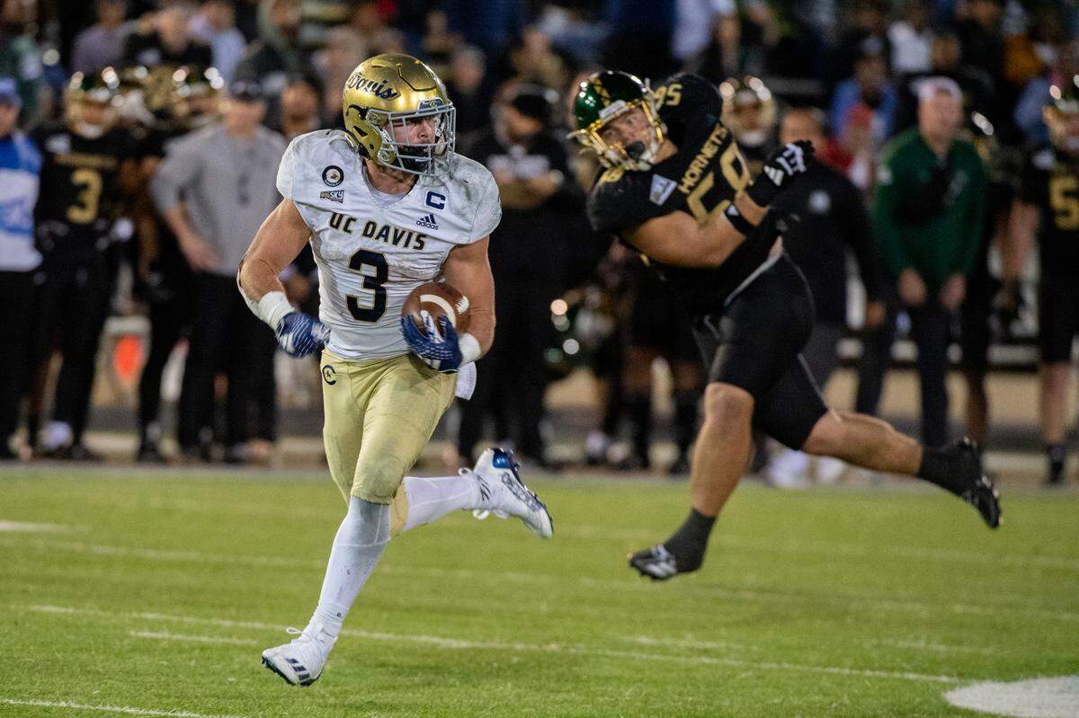 UC Davis Aggies running back Lan Larison (3) runs in the open field for a touchdown in the second half of the 70th Causeway Classic against the Sacramento State Hornets on Nov. 23, 2024 in Sacramento.