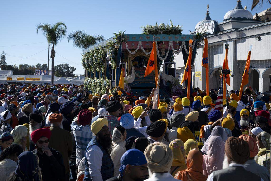 Members of the Sikh community gather around the main float before the start of Nagar Kirtan, also known as the Sikh Parade, in Sutter County on Sunday, Nov. 2, 2025.