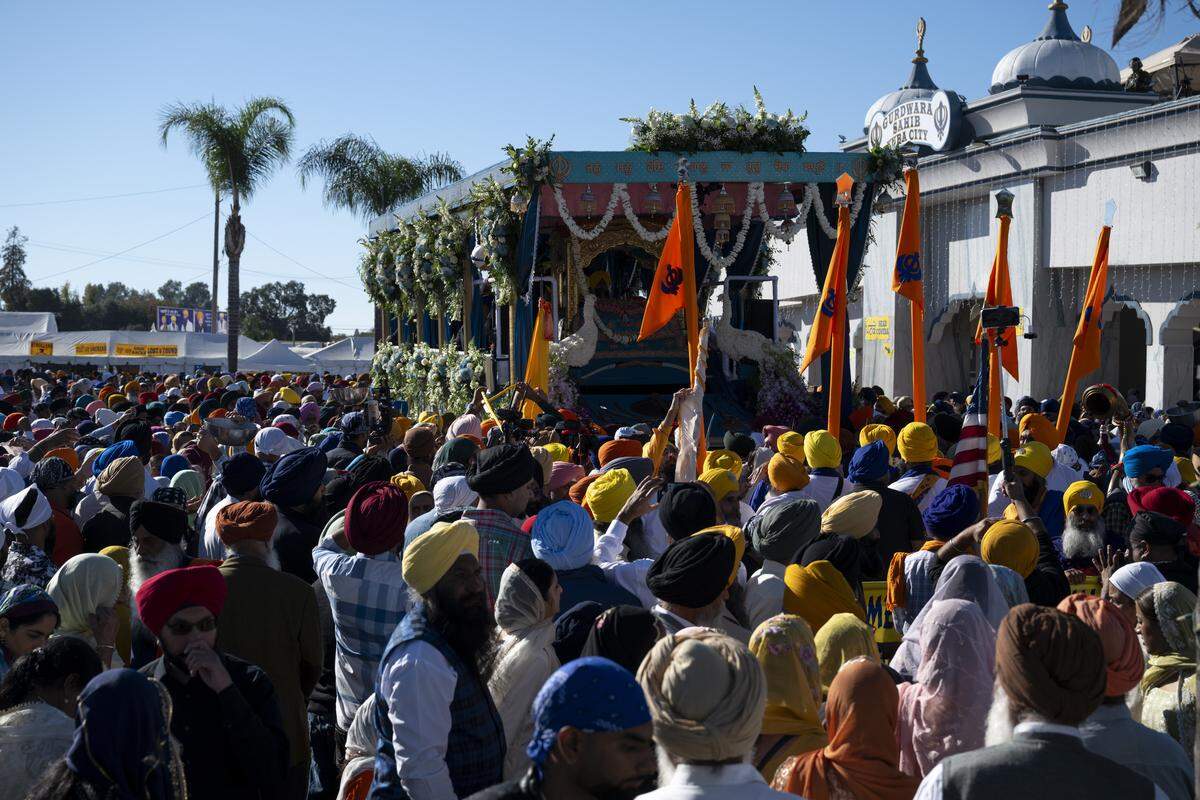 Members of the Sikh community gather around the main float before the start of Nagar Kirtan, also known as the Sikh Parade, in Sutter County on Sunday, Nov. 2, 2025.
