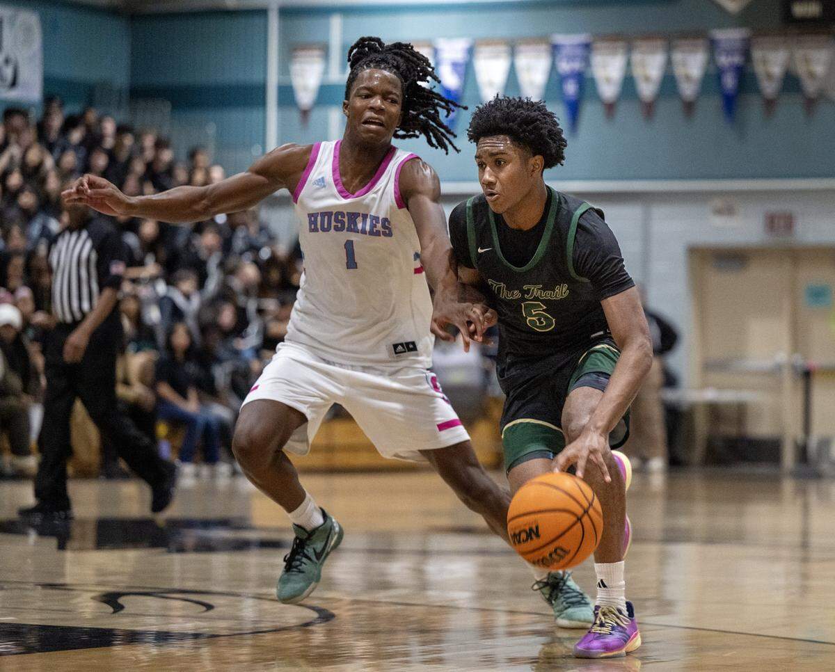 Sheldon Huskies' Baron Sabir (1) defends Monterey Trail Mustangs' Juleeyan Williams (5) in the first half of a game on Wednesday.