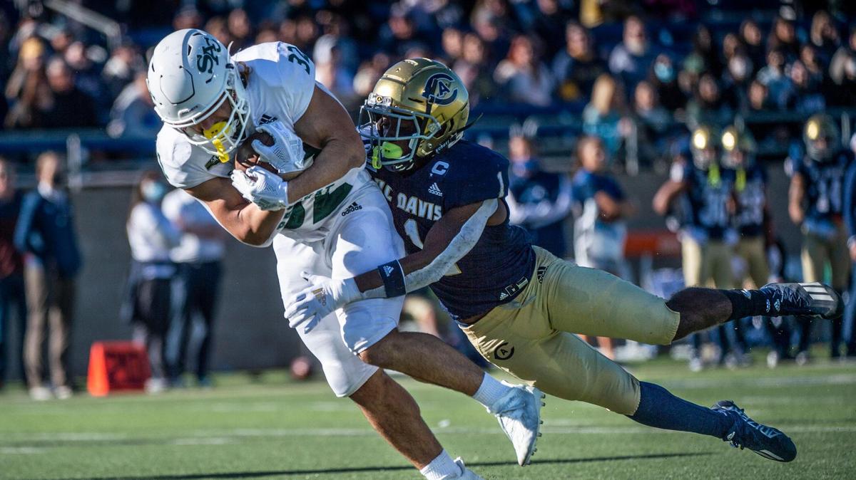 Sacramento State Hornets running back Cameron Skattebo (32) runs in for a touchdown against UC Davis Aggies defensive back Isaiah Thomas (1) on Saturday, Nov. 20, 2021 during the Causeway Classic football game at UC Davis Health Stadium.