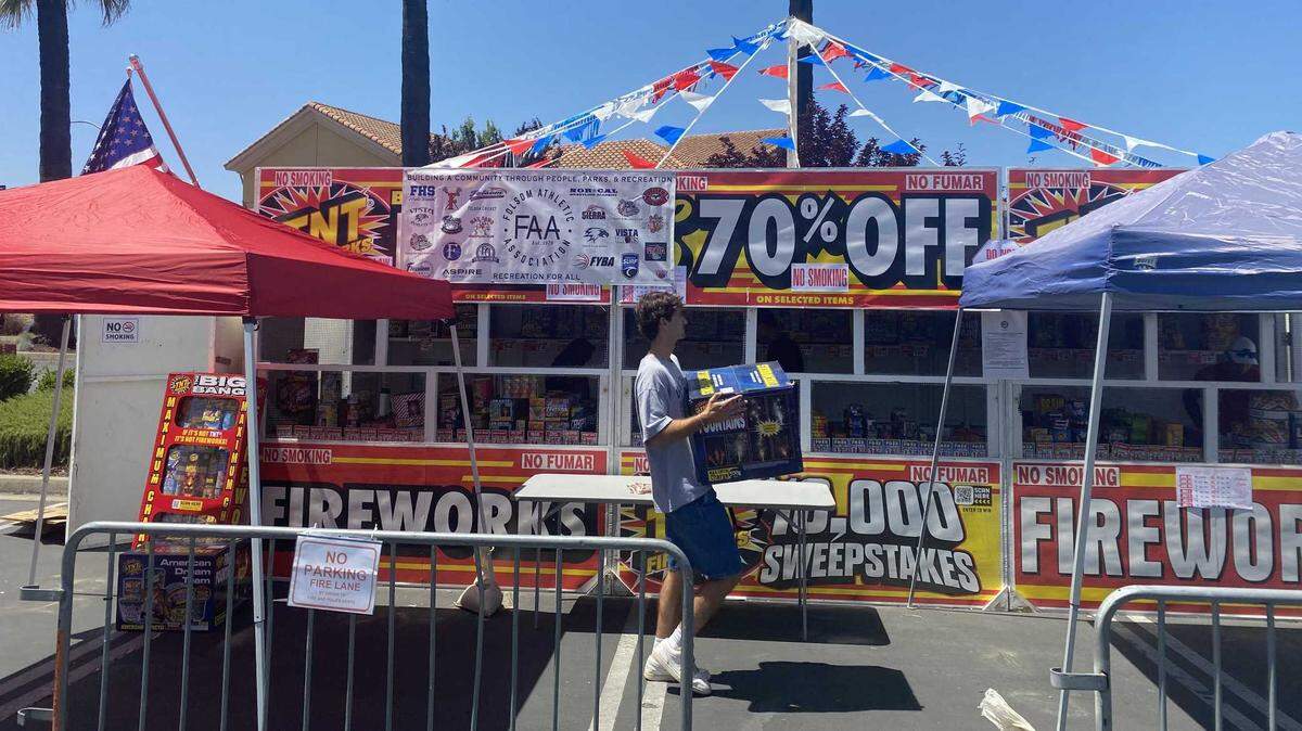 Griffin Kain stocks the shelves Saturday June 28, 2025, at the fireworks sales booth to benefit the Folsom Athletic Association at the Bel Air shopping center on East Bidwell Street in Folsom.