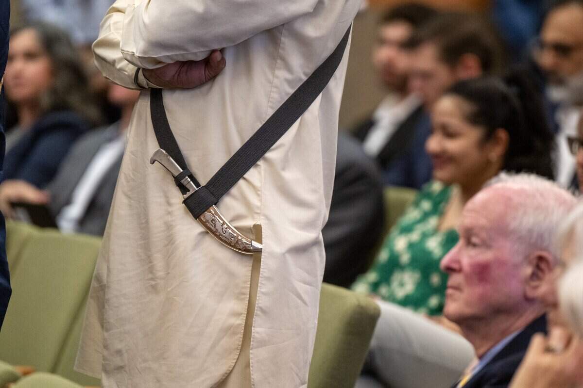 A kirpan – a short blade worn by some Sikhs as an article of faith – hangs at the side of Dr. Gurtej Singh during a Sacramento City Council meeting on Tuesday. It was the first meeting that kirpans were allowed after the council created a religious exemption for the weapons.