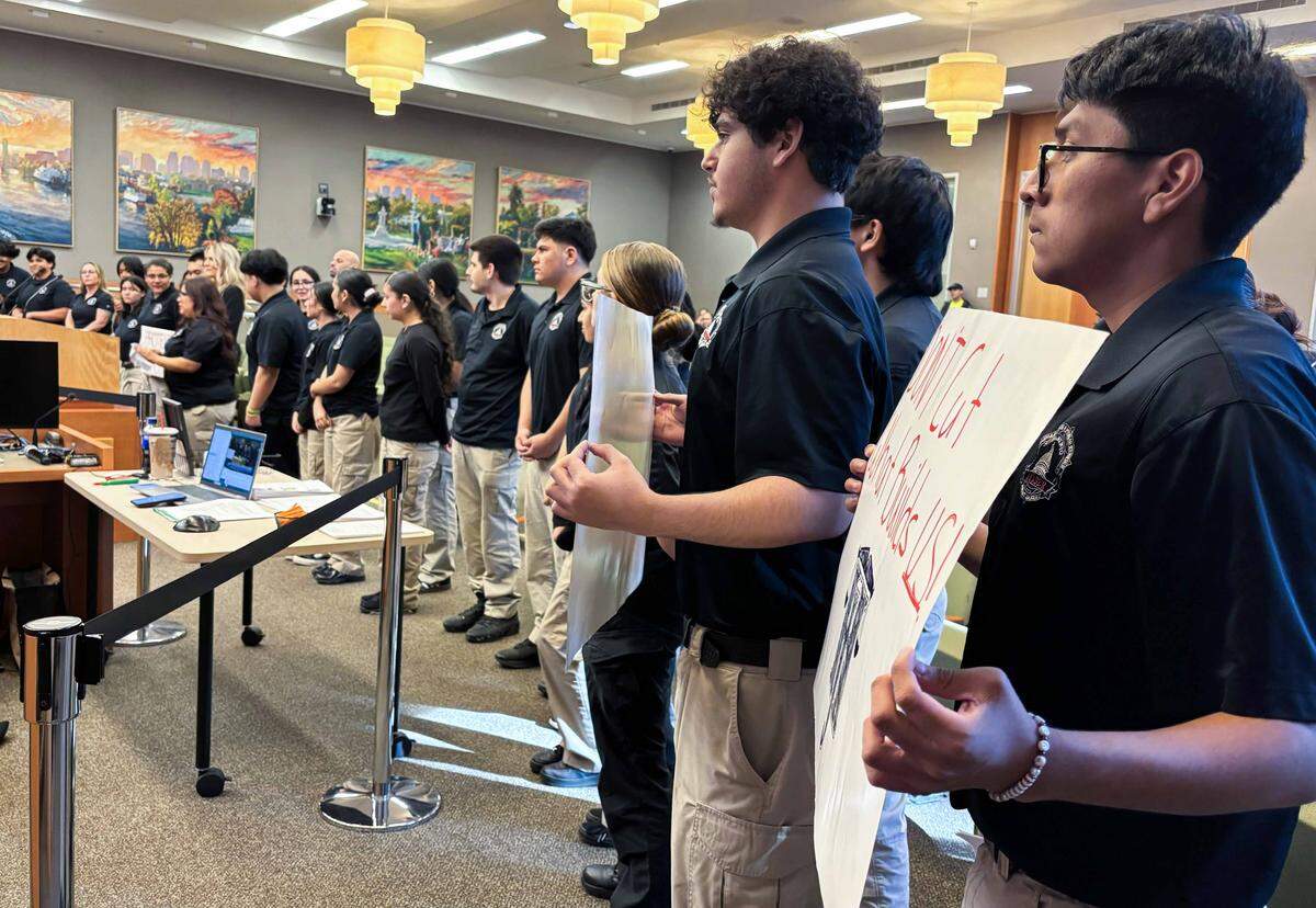 High school students involved in Sacramento Police Department Magnet Academy show their support for the program, a potential target for budget cuts, at a City Council meeting on March 3.